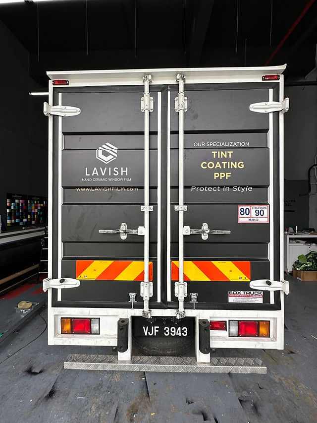Lorry driving safely at night in Selangor with high-visibility stickers