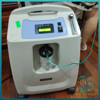 Elderly man using oxygen machine in his Puchong living room