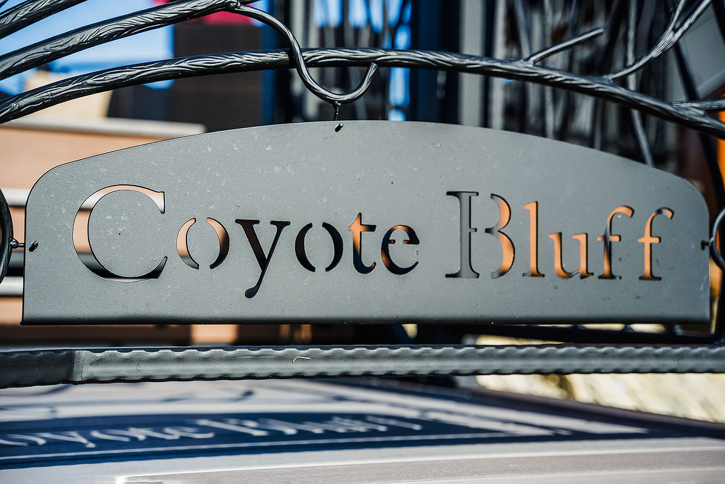 The wrought-iron Coyote Bluff sign