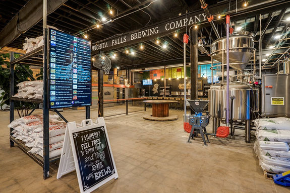 Wichita Falls Brewing Company interior with equipment and grain