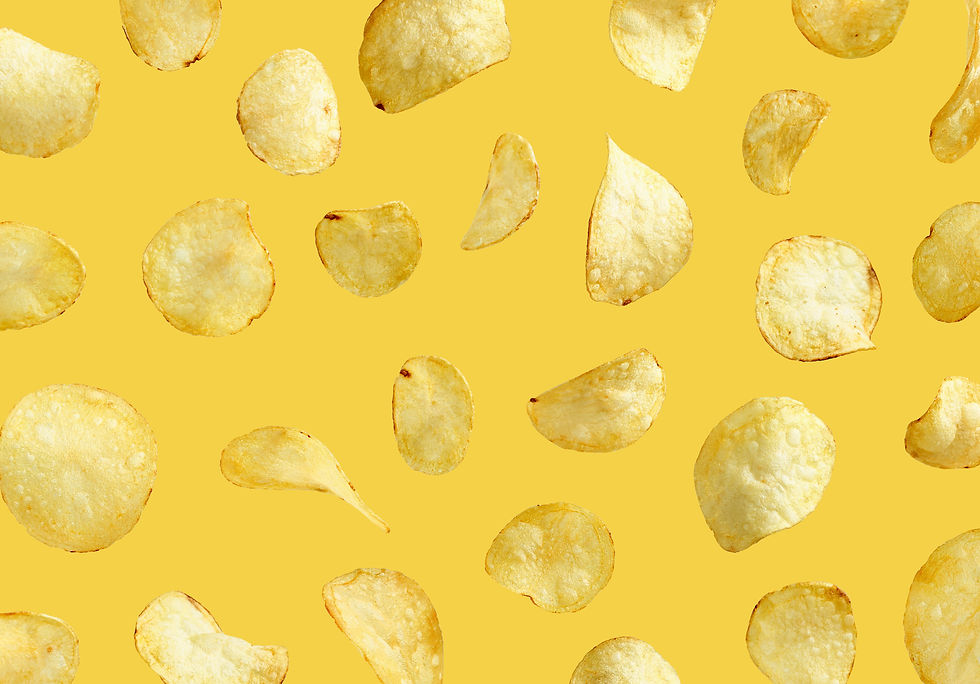 Levitating potato chips on yellow background.jpeg