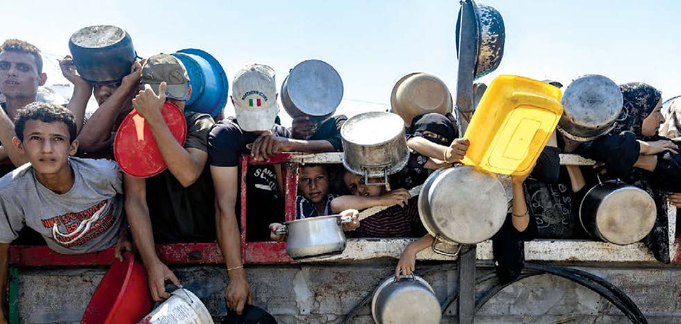 Displaced Palestinians wait in front of a charity kitchen in the western Gaza City area, July 23, 2025. (Saher Alghorra/The New York Times)