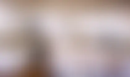 Modern kitchen with white painted cabinets, granite countertops, and stainless steel appliances