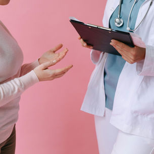 Woman receiving acupuncture for cancer treatment side effects to help reduce joint pain and improve comfort.
