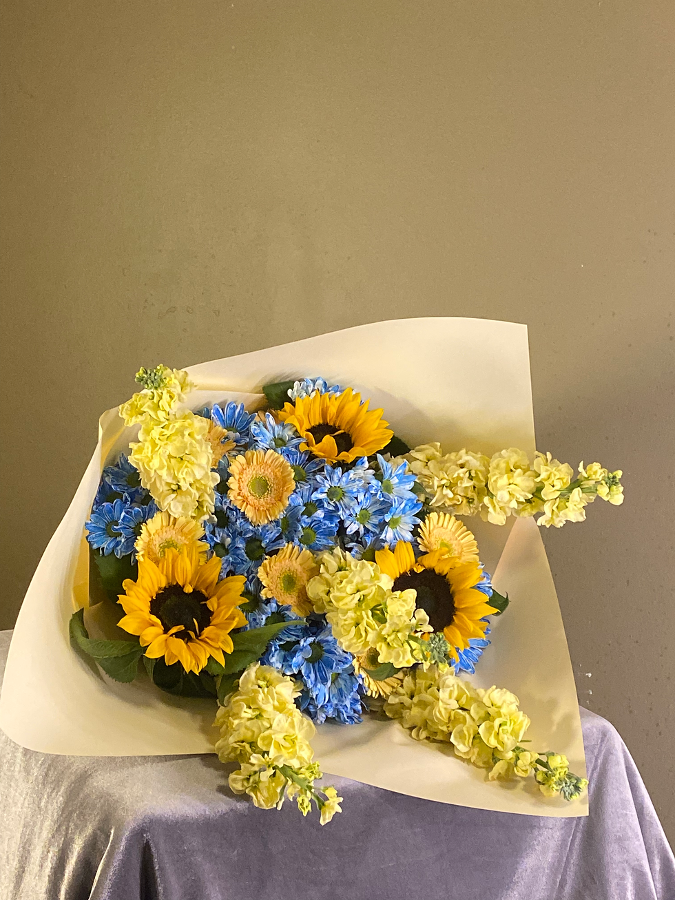 Close view of sunflowers, blue chrysanthemums, and eucalyptus bouquet