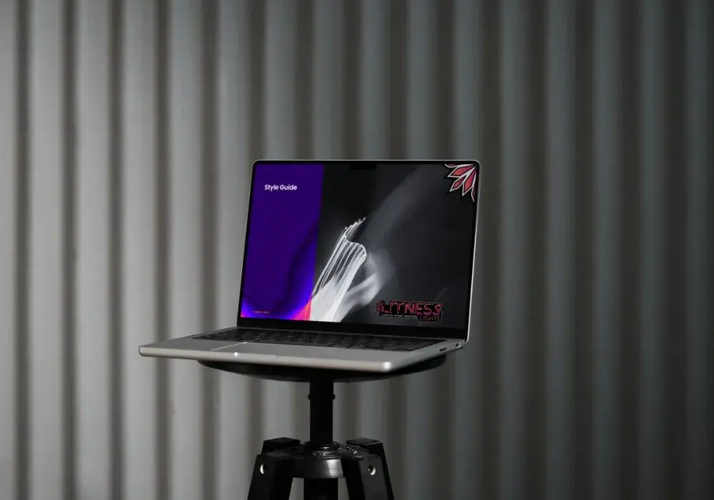 Open laptop displaying the Litness Lights style guide, designed by Create Discussion, showcasing bold and vibrant branding for an innovative lighting design company.