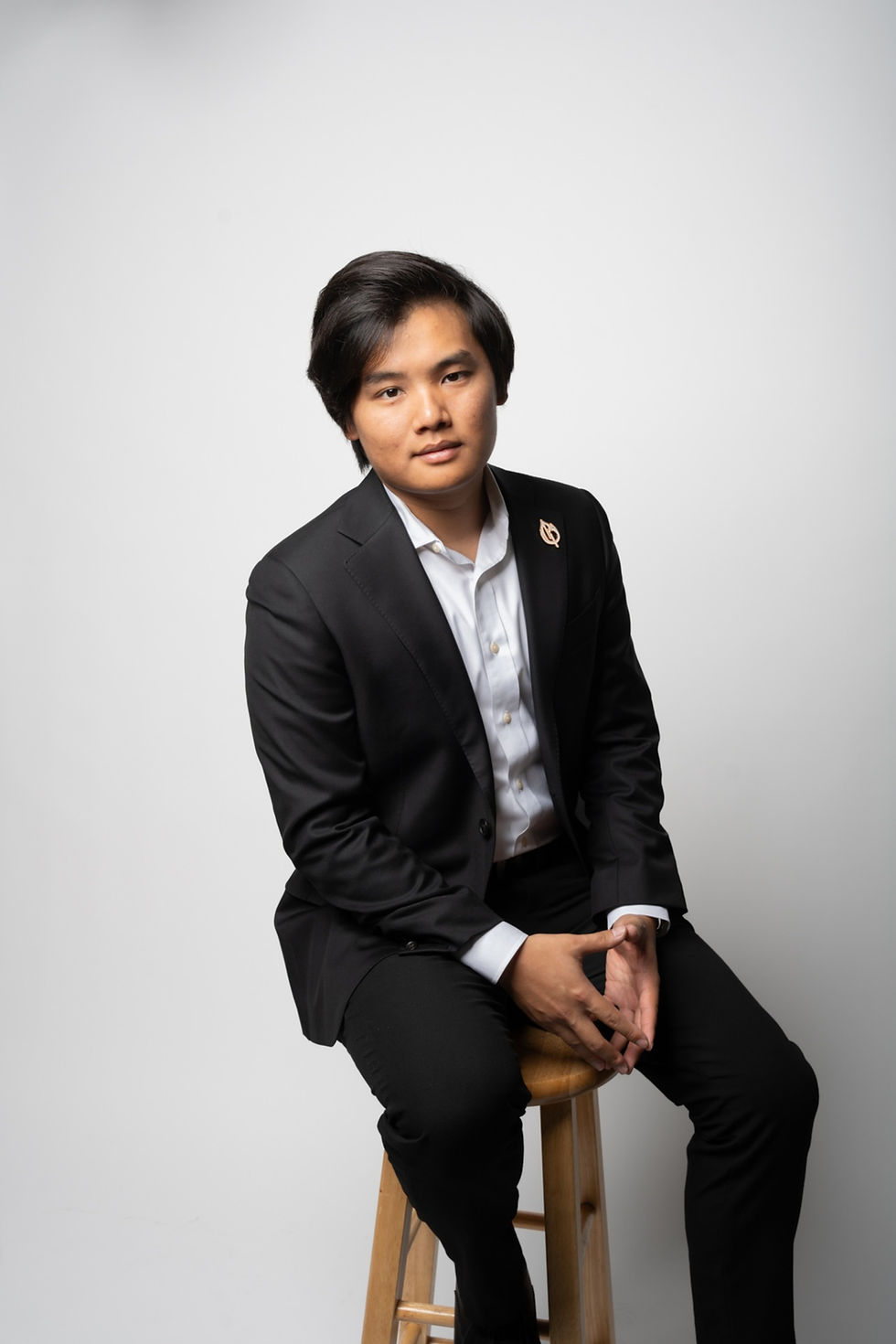 Norbert Tsi sits on a stool for team photoshoot for Paper Birch Collective, California Wedding Photographer and Videographer Team in Orange County