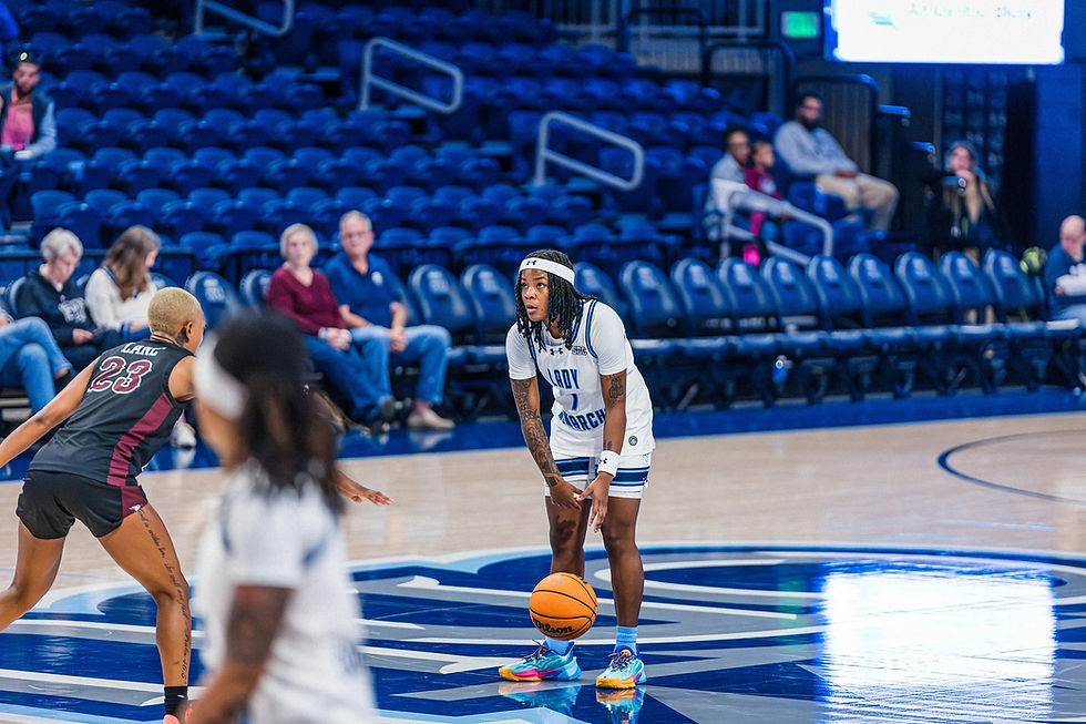 Basketball player dribbling the ball down court.