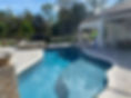 Completed backyard pool with attached spa and paver patio built by Trinity Pools in Citrus County