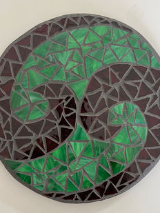 Glass mosaic of celtic swirls in Christmas holiday colors.