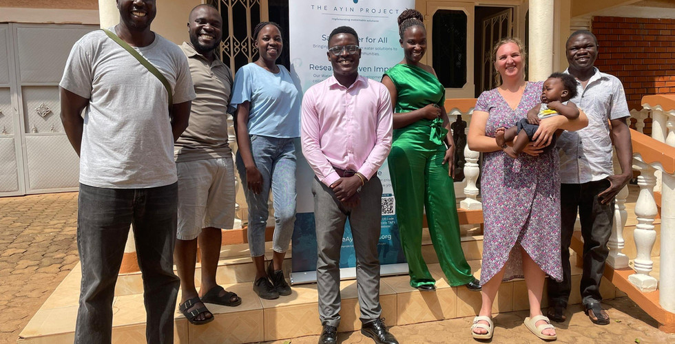 TAP Team stands with CAWST Team in front of the TAP Water Research and Development Center in Kampala