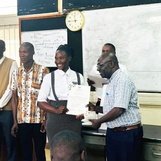 Lydia smiles as she receives her WASH Certification from Makarere University in the summer of 2025