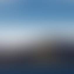 Wind turbines at the Makara wind farm overlooking the Wellington coastline, representing renewable energy and climate action in Aotearoa New Zealand.