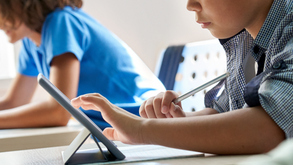 Students using digital tablets in a classroom, representing AI workshops for science educators and practical AI use cases in science classrooms.