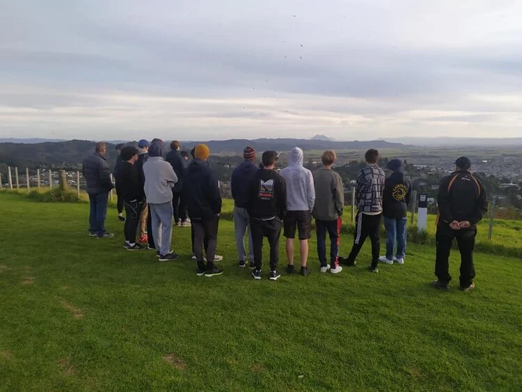 Secondary students gather at a lookout on the Pāpāmoa Hills, engaging in place-based learning focused on landscape, whakapapa, and environmental perspectives.