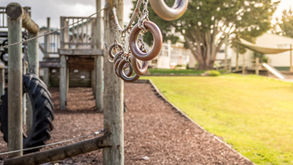 School playground with climbing equipment and tyre structures in a New Zealand primary school setting