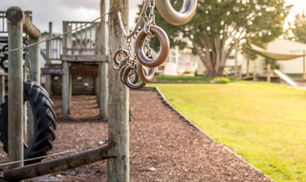 School playground with climbing equipment and tyre structures in a New Zealand primary school setting