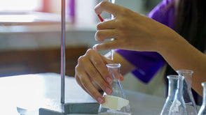 A student carefully performs a titration.