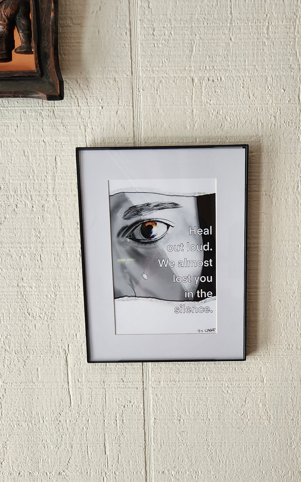 Heal Out Loud art print framed and hanging on a wall below another framed item.