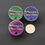 Thumbnail: Space themed acrylic pronoun pins "My Pronouns are They Them" next to quarter for scale
