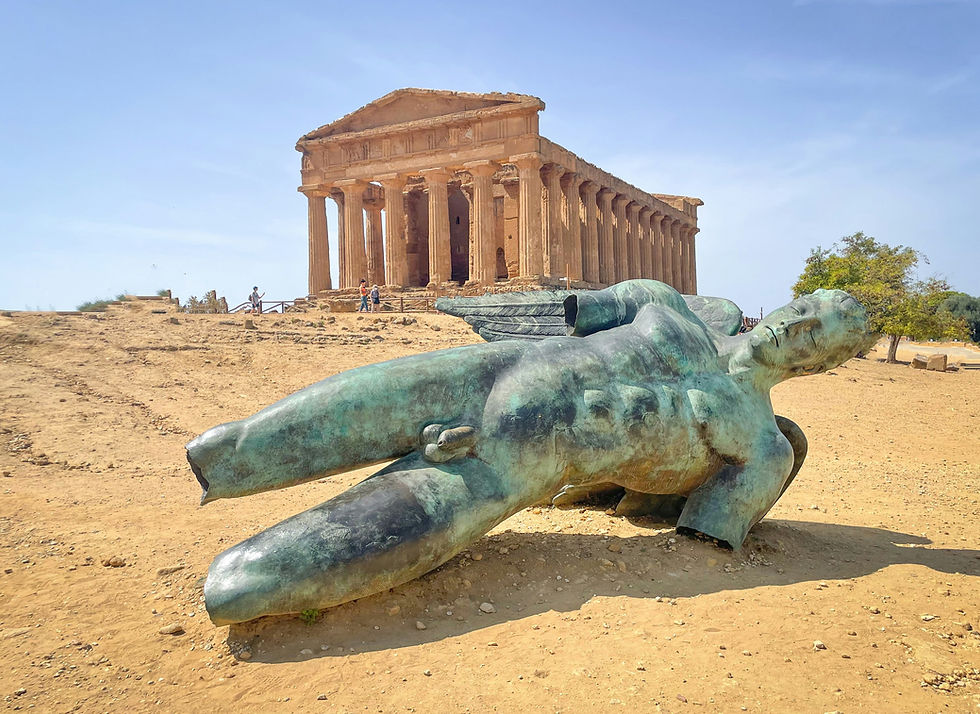Tempio della Concordia dorico ben conservato nella Valle dei Templi di Agrigento durante la luce dorata del tramonto, con l'Icaro Caduto in primo piano.