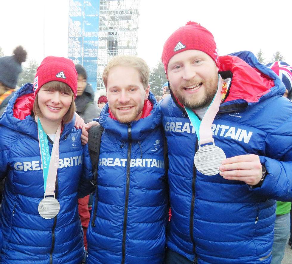 Tim with two ParalympicsGB athletes holding medals at PyeongChang 2018