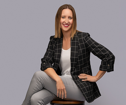 Personal branding portrait of a businesswoman seated in a plaid blazer in The Villages, FL studio.