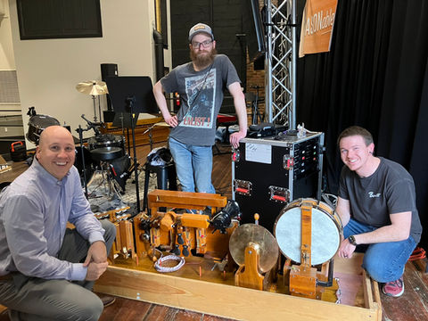 Friends of the Dawn members pose around the newly restored percussion components of the 1925 Wurlitzer organ.