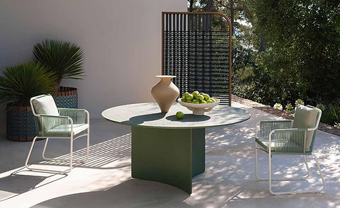 Aspic is a dining table in three new colors that preserve its sculptural character and refined exposed aggregate finish. Made from an innovative blend of natural mineral components and organic fibers, the ASPIC dining table combines long-lasting durability with three exclusive nature-inspired shades – Orange, Green, and Mole – designed to blend seamlessly into any outdoor setting.