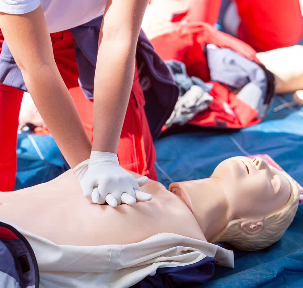Eye-level view of a CPR training mannequin on a gym floor