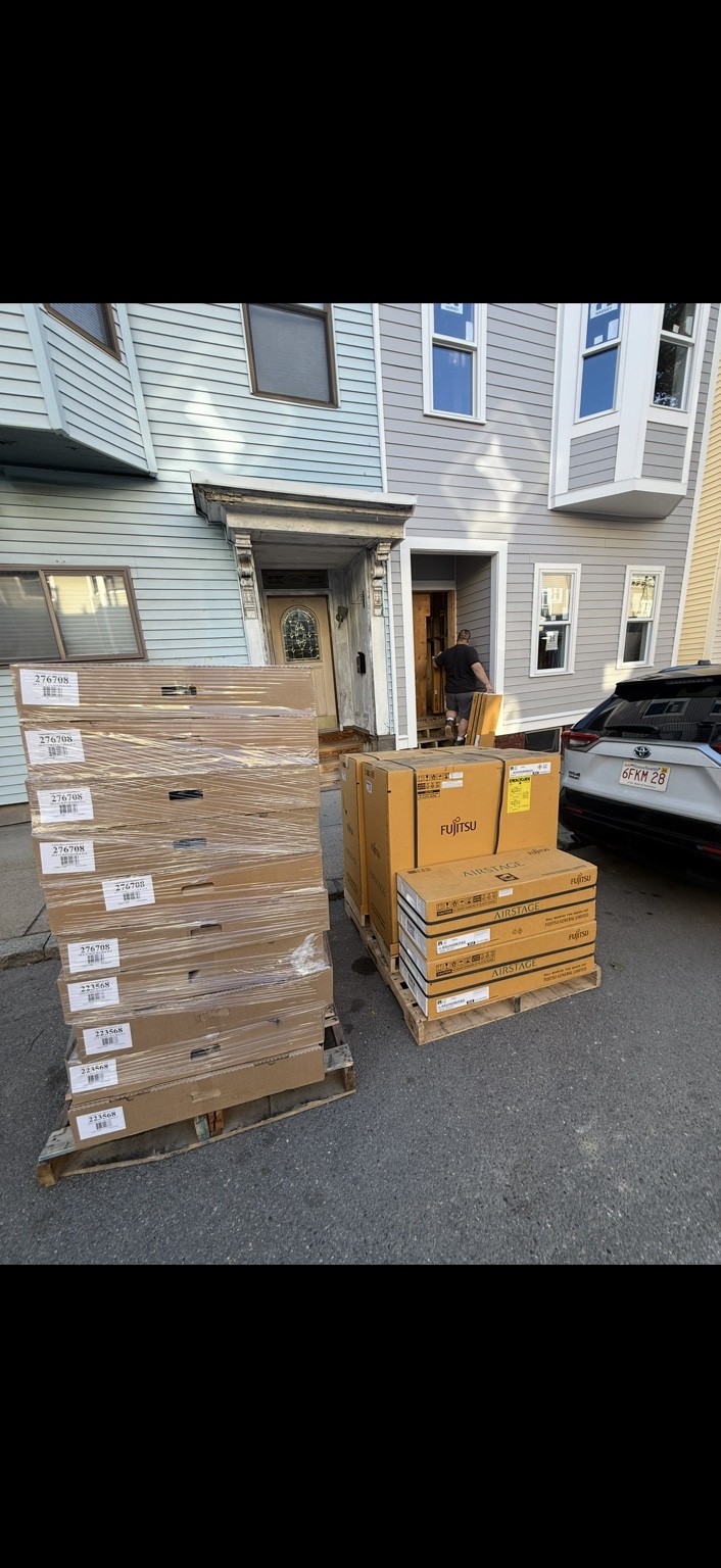 Packaged Fujitsu Airstage equipment delivered outside a residential construction site