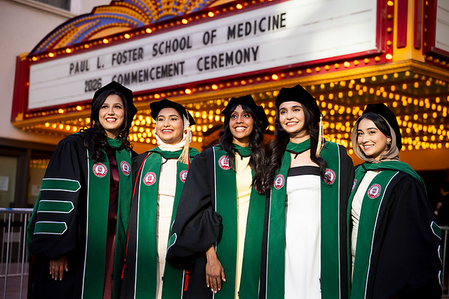 Texas Tech Graduates in front of the Plaza theater.