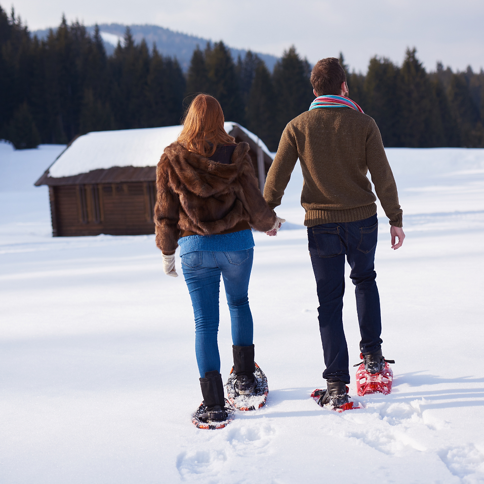 a couple snowshoeing in Maine's frozen wilderness