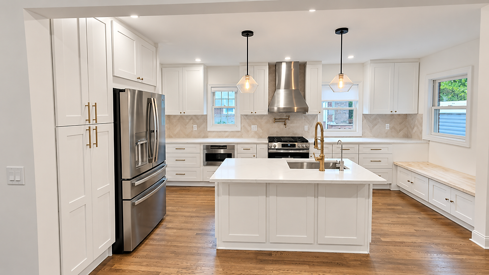 Completed Kitchen - North new Hyde Park, NY. Bright, modern white kitchen with stainless fridge, island sink, pendant lights, and wood floors