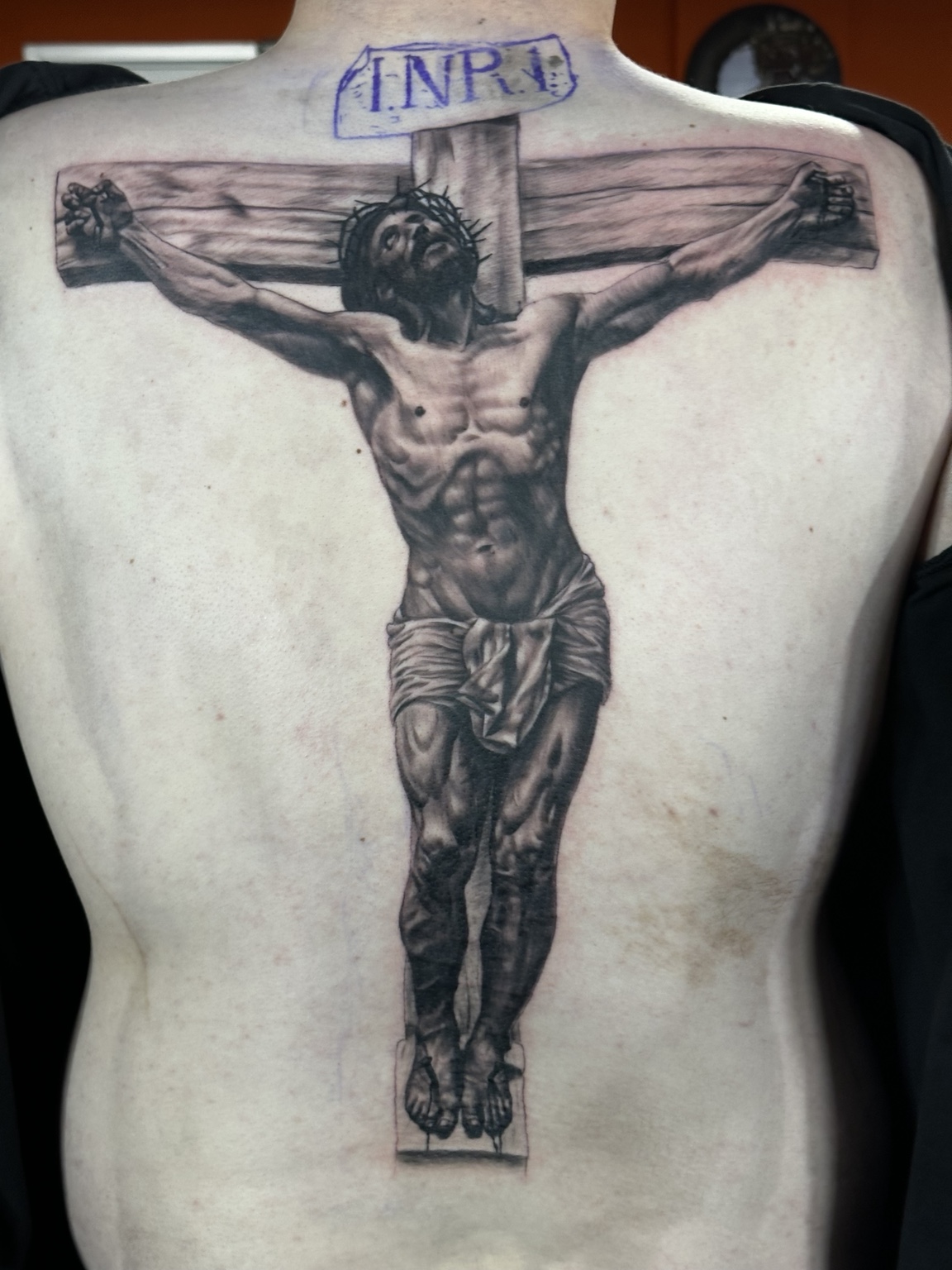 Black-and-grey realism crucifixion back tattoo by Bad Apple Tattoo in Madison