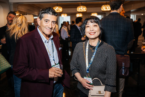 Smiling man and woman with conference badges, including PBG BioPharma, at a warmly lit networking event. CanExec Summit 2026