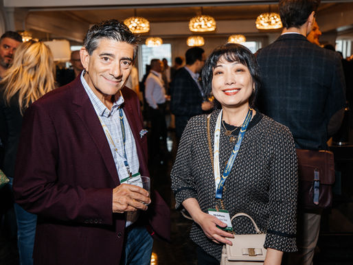 Smiling man and woman with conference badges, including PBG BioPharma, at a warmly lit networking event. CanExec Summit 2026