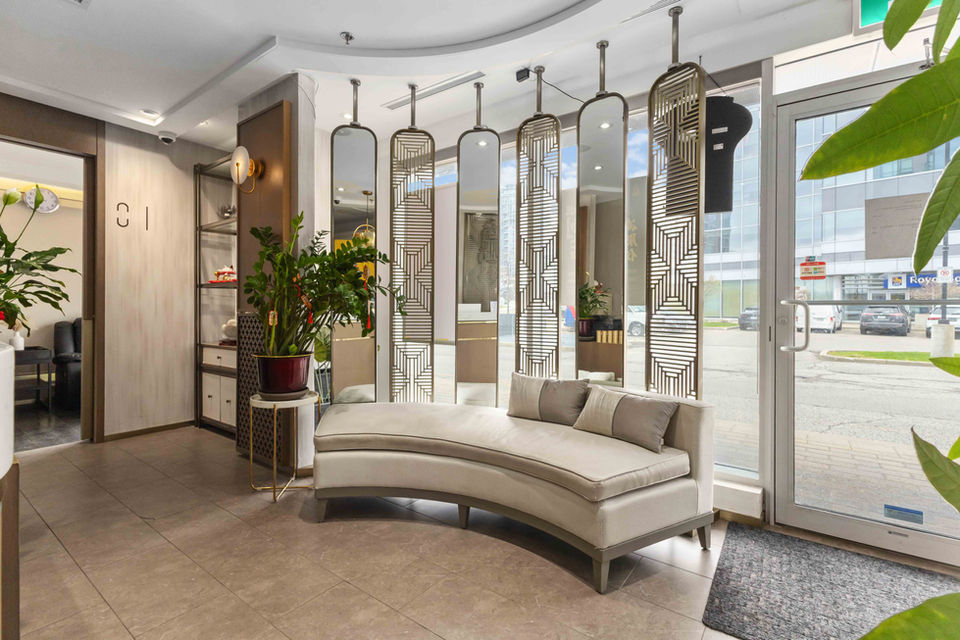 Reception lounge with natural wood furniture and a calming energy flow.