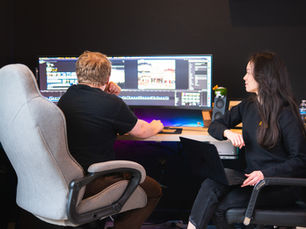 editor and project coordinator collaborating on video edits