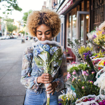 women smelling flowers