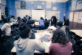 Teacher helping a group of students in the classroom