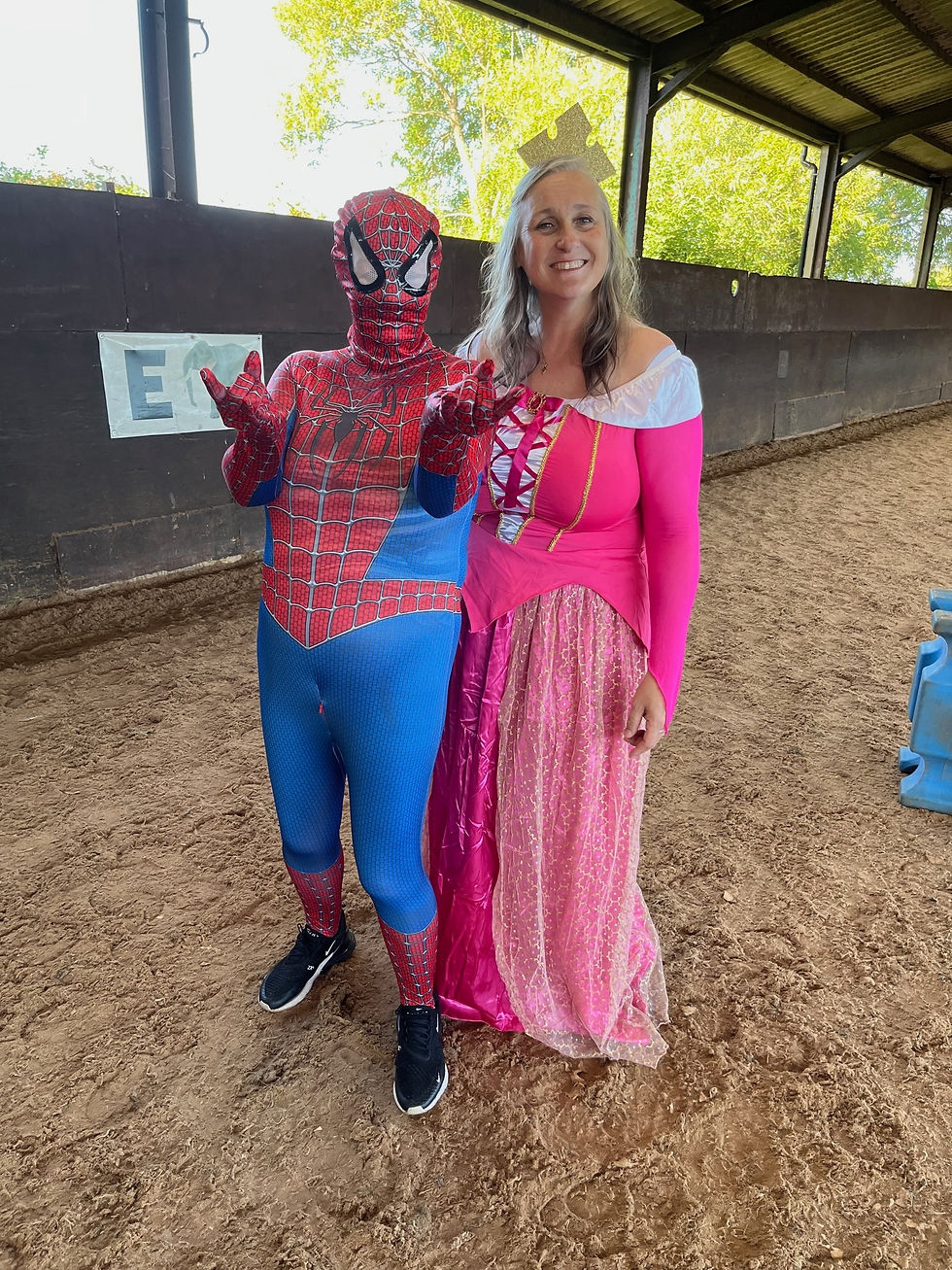 Someone dressed as Spiderman and a lady dressed in a pink princess costume.