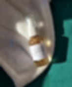 bottle of product with a white and green background