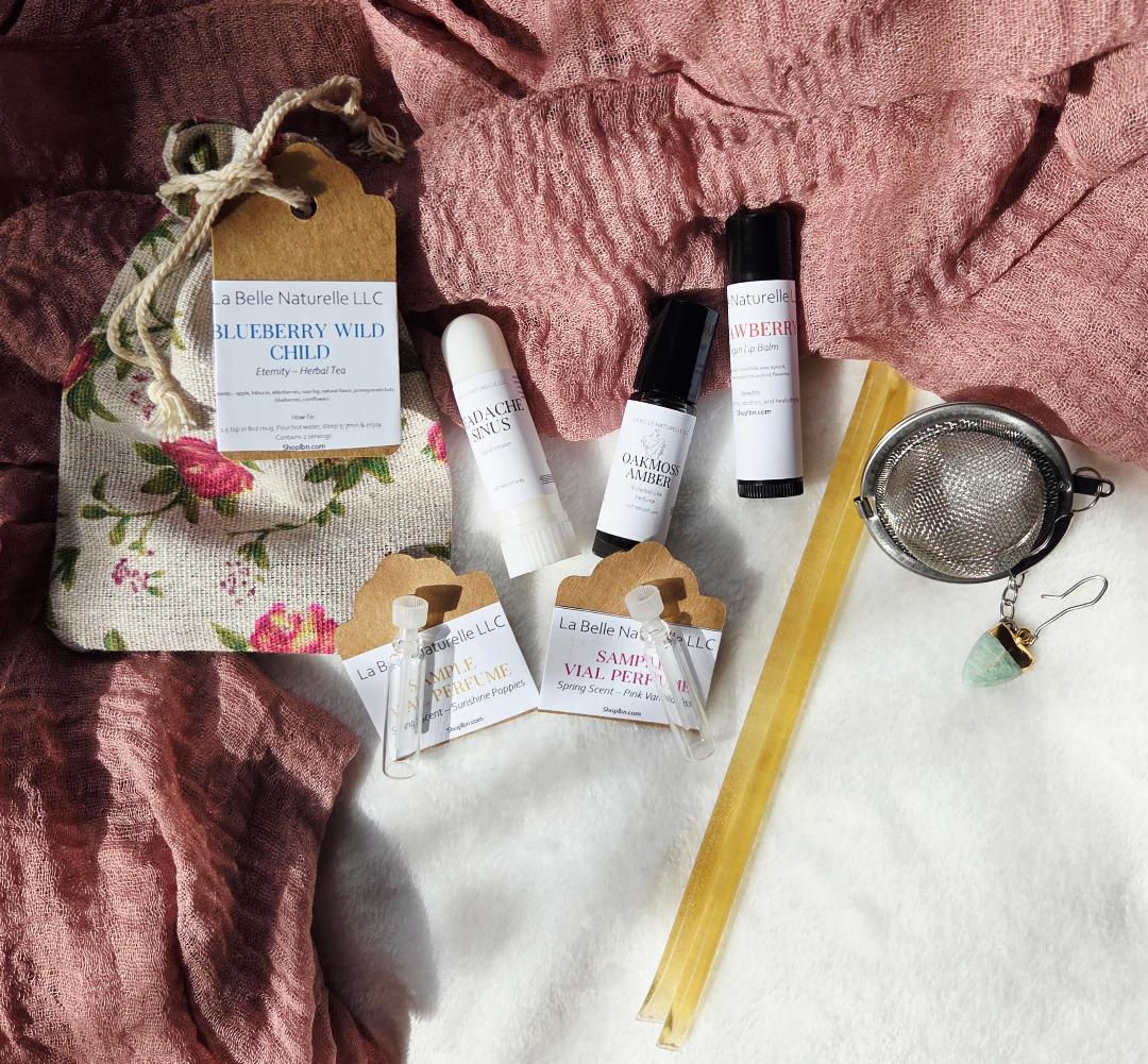 tea, nasal stick, sample spring scents, lip balm, rollerball perfume, honey sticks all laid out.