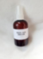 amber bottler white top on a white back drop