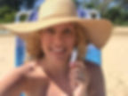 woman with hat holding a lip balm tube