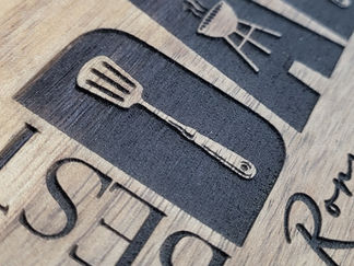 close up of details and the relief of a wooden board engraved with the letters and icons by Creative Candies & gifts
