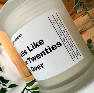 close up of a label for a candle thats says smells lilke your twenties are over