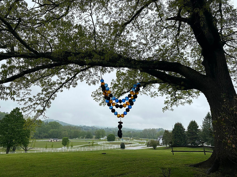 The holy grounds of the farm and the blown glass mala beads in the tree help set the stage for healing.