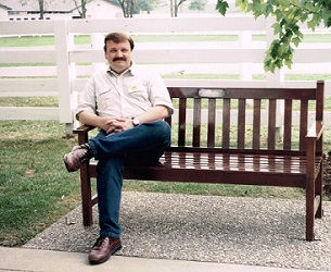 This is a photo on myself sitting on a bench at the Kentucky Horse Parl.